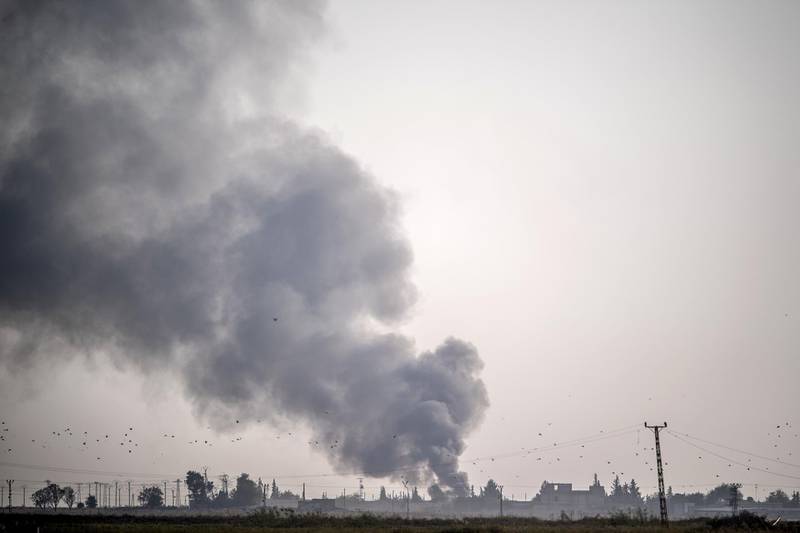 Smokes rises from the Syrian town of Tal Abyad after Turkish bombings, in a picture taken from the Turkish side of the border near Akcakale in the Sanliurfa province. AFP