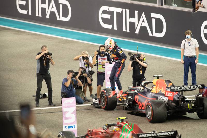 Race winner and 2021 F1 World Drivers Champion Max Verstappen of Netherlands and Red Bull Racing celebrates on the podium during the F1 Grand Prix of Abu Dhabi at Yas Marina Circuit. Victor Besa/The National.