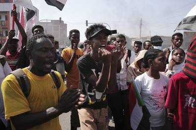 People chant slogans during a protest to denounce the military takeover. AP