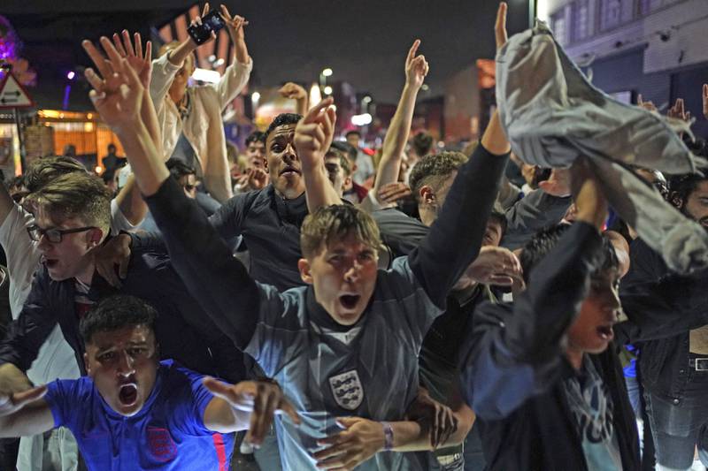 Fans on the streets celebrate England qualifying for the Euro 2020 final after watching the semi final match between England and Denmark, in Birmingham, England.