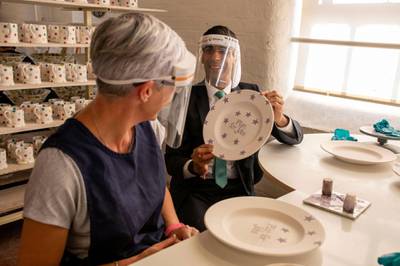 STOKE-ON-TRENT, ENGLAND - SEPTEMBER 14: Chancellor Rishi Sunak decorates a plate with the words 'Plan For Jobs' during a visit to the Emma Bridgewater pottery after employees returned back to work after being furloughed on September 14, 2020 in Stoke-on-Trent, England. (Photo by Andrew Fox - WPA Pool / Getty Images)