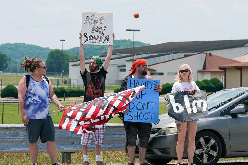 Black Lives Matter supporter await the arrival of the Confederate Flag supports on Speedway Blvd outside of the Talladega Superspeedway. REUTERS