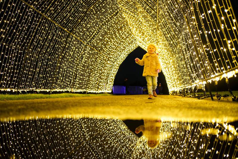 Eliza Homer, 4, runs through a section of the outdoor light trail at Winter Glow, at Three Counties Showground in Malvern, Worcestershire, on Monday. PA