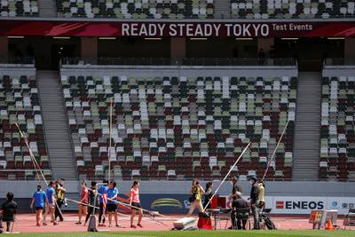 Athletes hold pole vaults at the morning session of the Athletics test event. Reuters