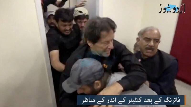 Mr Khan is helped after the shooting. Reuters