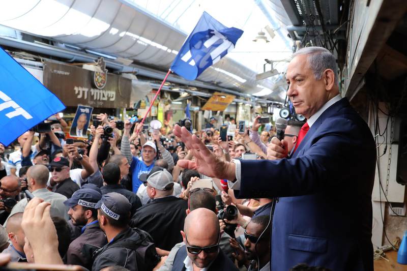 epa07491896 Israeli Prime Minister and Chairman of the Likud Party Benjamin Netanyahu waves to supporters as he tours the Mahane Yehuda market with his wife during the final stage of his election campaign in Jerusalem, Israel, 08 April 2019.  Israel will go to the polls on 09 April 2019.  EPA/ABIR SULTAN