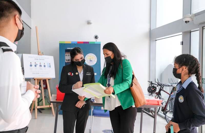 Parents present their children's PCR tests at The British School Al Khubairat in Abu Dhabi.