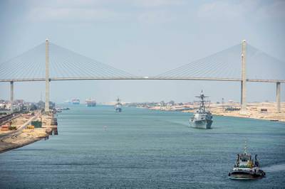 The guided-missile cruiser USS Monterey (CG 61), left, and the guided-missile destroyer USS Thomas Hudner (DDG 116) sail behind the aircraft carrier USS Dwight D. Eisenhower (CVN 69) during a Suez Canal transit, in this picture taken April 2, 2021 and released by U.S. Navy on April 3, 2021. Sophie A. Pinkham/U.S. Navy/Handout via REUTERS ATTENTION EDITORS- THIS IMAGE HAS BEEN SUPPLIED BY A THIRD PARTY.