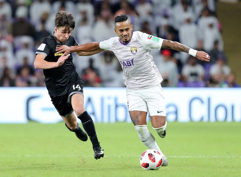 Al Ain, United Arab Emirates - December 12, 2018: Caio of Al Ain and Jack-Henry Sinclair of Wellington compete during the game between Al Ain and Team Wellington in the Fifa Club World Cup. Wednesday the 12th of December 2018 at the Hazza Bin Zayed Stadium, Al Ain. Chris Whiteoak / The National
