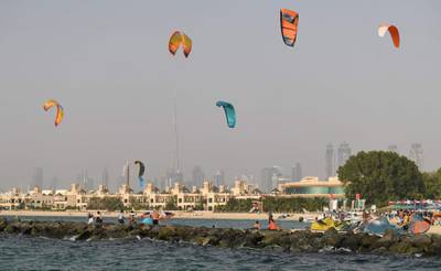 People kite-surf during the Dubai watersport festival, organised by the Dubai International Marine Club (DIMC), in the Gulf emirate on June 26, 2020.  / AFP / KARIM SAHIB

