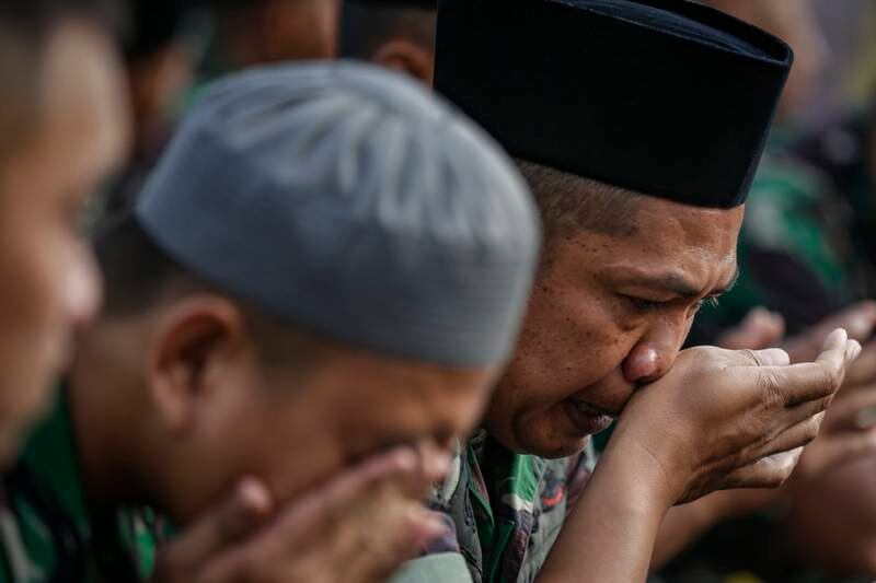 A soldier's reaction during a mass prayer for the victims, outside Kanjuruhan Stadium on October 4. EPA 