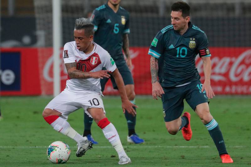 Peru's Christian Cueva, left, is challenged by Argentina's Lionel Messi. AFP