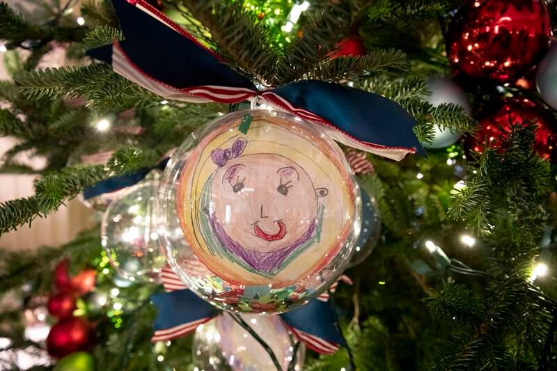 Ornaments depicting self-portraits made by pupils of the recipients of the 2021 Teacher of the Year award decorate a Christmas tree in the State Dining Room. EPA