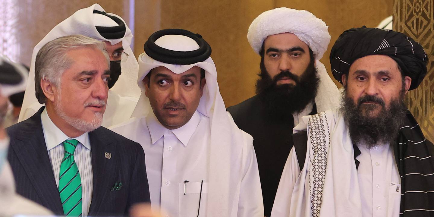 High Council for National Reconciliation head Abdullah Abdullah, left, Qatar's envoy on counter-terrorism Mutlaq Al Qahtani, second from left, and Taliban lead negotiator Mullah Abdul Ghani Baradar, third from left, at the talks. AFP
