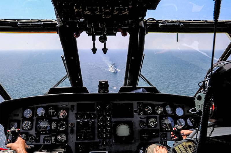 Iranian helicopter pilots fly during joint naval military drills between Iran, Russia and China in the Gulf of Oman. AFP