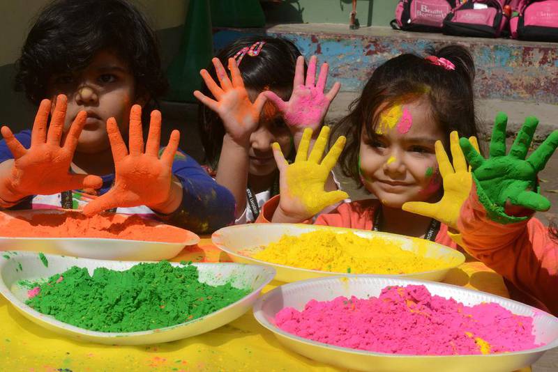 Indian children from the Bright Academy pose with coloured powder known as gulal used during the Holi festival in Siliguri on March 4. Diptendu DUTTA / AFP Photo