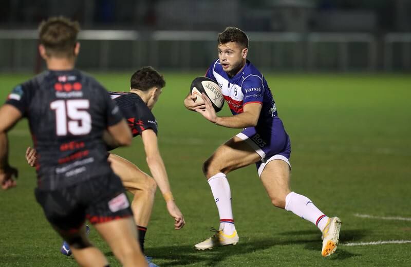 Josh Britland, right, of Jebel Ali Dragons takes on Dubai Exiles at The Sevens. Exiles booked their place in the UAE Premiership final with a 35-22 win over the Dragons.