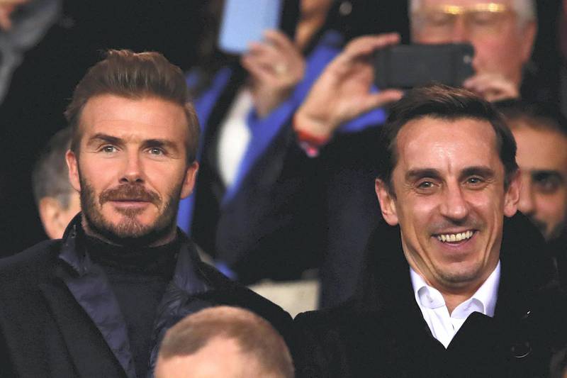 PARIS, FRANCE - MARCH 06: David Beckham and Gary Neville look on from the crowd during the UEFA Champions League Round of 16 Second Leg match between Paris Saint-Germain and Real Madrid at Parc des Princes on March 6, 2018 in Paris, France.  (Photo by Chris Brunskill Ltd/Getty Images)