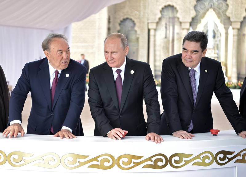 epa06945844 President of Kazakhstan Nursultan Nazarbayev (L), President of Russia Vladimir Putin (C) and President of Turkmenistan Gurbanguly Berdimuhamedow (R) attend ceremony of release of young sturgeon during a walk along the embankment of the Caspian Sea at the 5th Caspian summit at the Friendship Palace in Aktau, the Caspian Sea port in Kazakhstan, 12 August 2018. The leaders of five countries bordering the Caspian Sea - Caspian Five - Russia, Iran, Kazakhstan, Azerbaijan, and Turkmenistan sign the Convention of the legal status of the Caspian Sea at the Aktau summit on 12 August.  EPA/ALEXEY NIKOLSKY/SPUTNIK/KREMLIN / POOL MANDATORY CREDIT