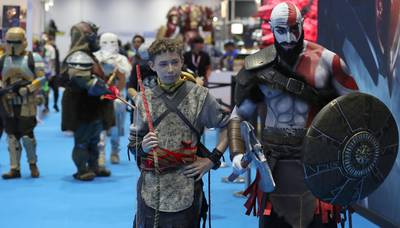 Cosplayers dressed as God of War character Kratos, right,  and his son Atreus.