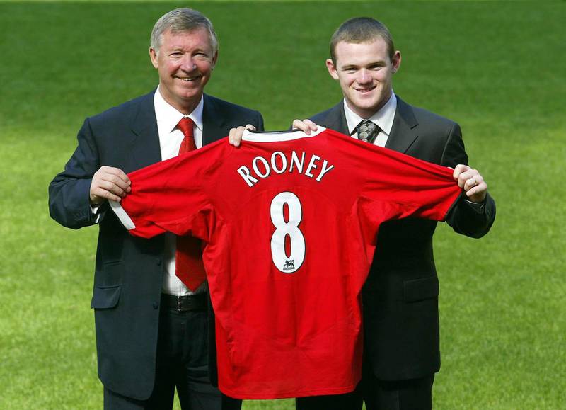 New Manchester United signing Wayne Rooney poses for photographers alongside manager Sir Alex Ferguson on September 01, 2004. PA