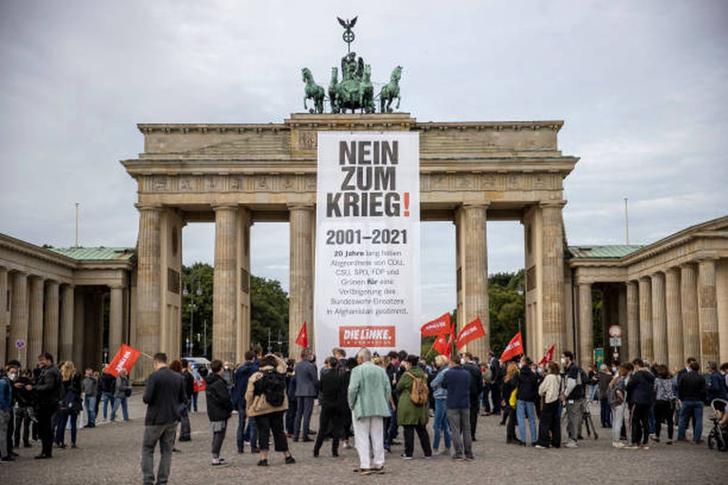 Supporters of the Linke party, which hopes to reduce refugee flows by stopping arms exports, hold a protest at the Brandenburg Gate in Berlin. Getty 