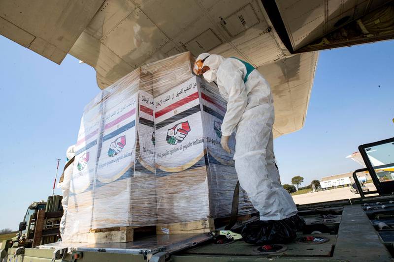Airport staff unload medical aid sent to Italy from Egypt near Rome. EPA