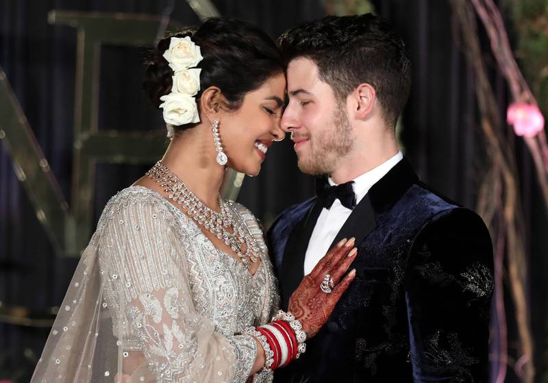 epa07248854 YEARENDER DECEMBER 2018

Newlyweds, Bollywood actress Priyanka Chopra (L) and US musician Nick Jonas (R) pose for photographs during a reception in New Delhi, India, 04 December 2018. According to media reports, the couple hosted wedding celebrations in Jodphur on 01 and 02 December.  EPA/RAJAT GUPTA