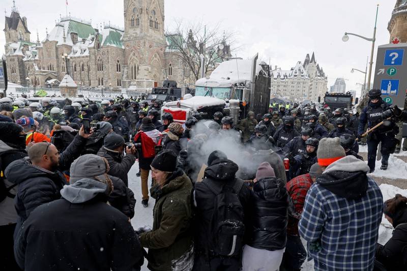 Canadian police officers march on protesters at Parliament Hill in Ottawa. Photo: Reuters
