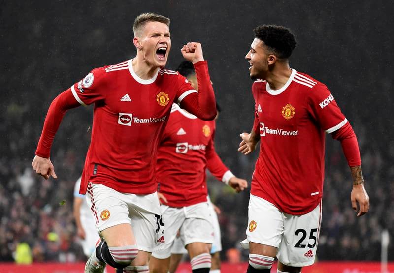 Scott McTominay of Manchester United celebrates with teammate Jadon Sancho, right, after the team's first goal in their home match against Burnley on Thursday. EPA