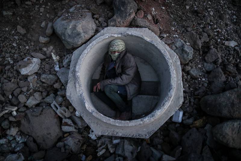 An Afghan boy hides in a sewer pipe near Van city after crossing the Iran-Turkey border. EPA