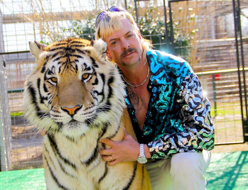 (FILES) In this file undated photo courtesy of Netflix shows Joseph "Joe Exotic" Maldonado-Passage with one of his tigers obtained on january 20, 2020. A new episode of Netflix's wildly popular "Tiger King" will air this weekend, the company said on April 9, 2020, bringing fans up-to-date with the lives of the smash hit zookeeper documentary's surreal subjects. The series about a gay, mullet-wearing private zoo owner who calls himself "Joe Exotic" -- now in prison for murder-for-hire -- has become a US cultural phenomenon, providing welcome relief to a nation under coronavirus lockdown.
 - RESTRICTED TO EDITORIAL USE - MANDATORY CREDIT "AFP PHOTO / NETFLIX" - NO MARKETING - NO ADVERTISING CAMPAIGNS - DISTRIBUTED AS A SERVICE TO CLIENTS
 / AFP / Netflix US / - / RESTRICTED TO EDITORIAL USE - MANDATORY CREDIT "AFP PHOTO / NETFLIX" - NO MARKETING - NO ADVERTISING CAMPAIGNS - DISTRIBUTED AS A SERVICE TO CLIENTS
