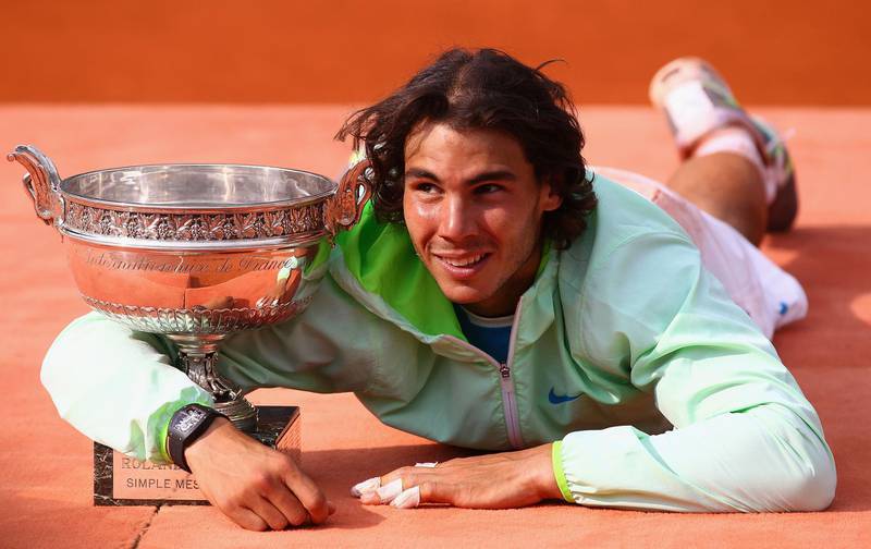 PARIS - JUNE 06:  Rafael Nadal of Spain celebrates with the trophy after winning the men's singles final match between Rafael Nadal of Spain and Robin Soderling of Sweden on day fifteen of the French Open at Roland Garros on June 6, 2010 in Paris, France.  (Photo by Julian Finney/Getty Images)