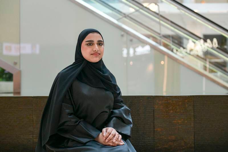 Mouza Al Hammadi works as a cashier at a supermarket in Abu Dhabi. Khushnum Bhandari / The National
