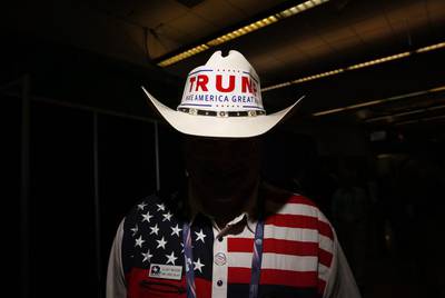 A delegate from Texas wears a cowboy hat with a campaign bumper sticker supporting Republican presidential nominee Donald Trump. Daniel Acker/Bloomberg