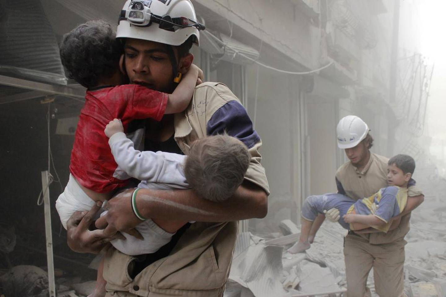 White Helmets rescue children in Aleppo after what activists said was an air strike by regime forces. Sultan Kitaz / Reuters