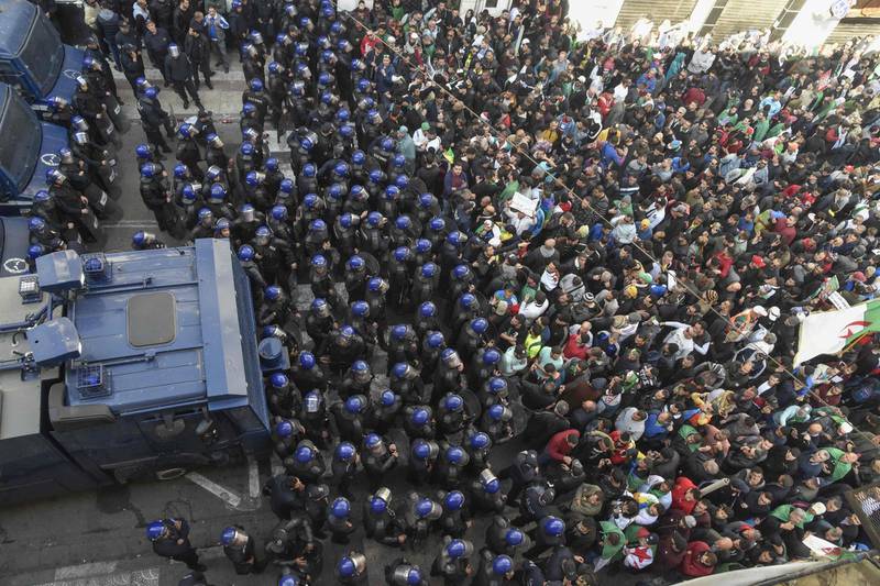 Algerian riot police block the progress of an anti-government demonstration heading towards the presidential palace in the capital Algiers. AFP