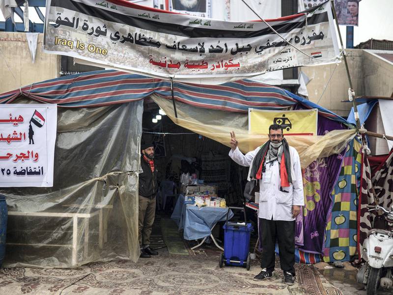 Dr Al Abadi stands outside his makeshift clinic in Tahrir Square. Luke Pierce for The National
