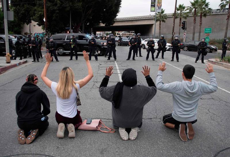Demonstrators face a row of police as they block a road leading to the 110 freeway to protest the death of George Floyd, in downtown Los Angeles, California on May 29, 2020. AFP