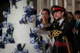 Jordan's Crown Prince Hussein and Princess Rajwa cut the cake during their wedding in Amman. AP