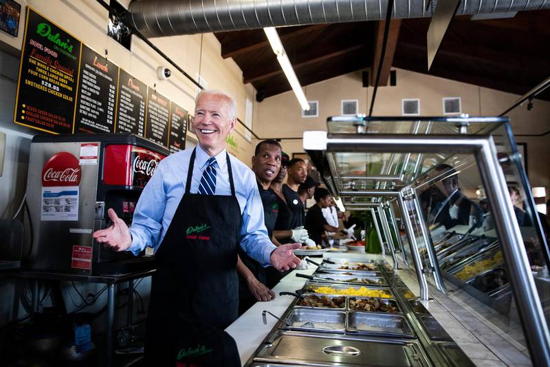 epa07725479 Democratic candidate for Presidency and Former US Vice President, Joe Biden serves food at 'Dulan's on Crenshaw' restaurant prior to a fundraiser in Los Angeles, California, USA, 18 July 2019.  EPA-EFE/ETIENNE LAURENT
