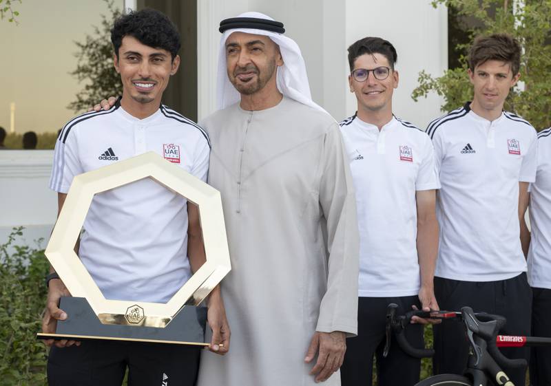 Sheikh Mohamed bin Zayed, Crown Prince of Abu Dhabi and Deputy Supreme Commander of the Armed Forces, stands for a photograph with a cyclist from the UAE Tour 2022. All photos: Ministry of Presidential Affairs