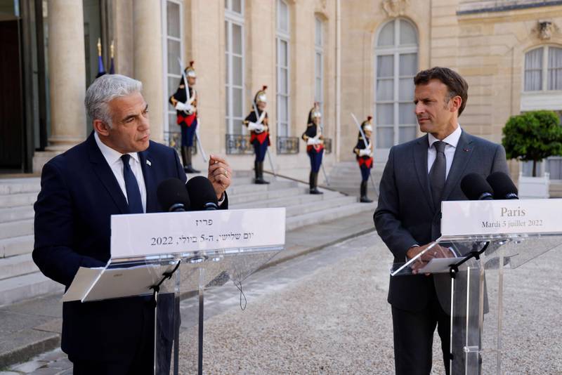 France's President Emmanuel Macron (R) and Israel's Prime Minister Yair Lapid make a statement following their meeting at the Elysee Palace in Paris. AFP