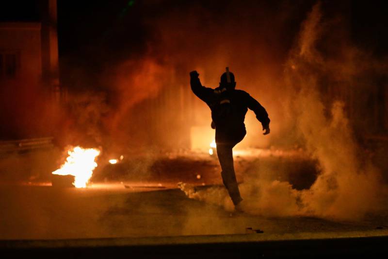 A demonstrator kicks a tear gas canister during Wednesday's clashes. Reuters