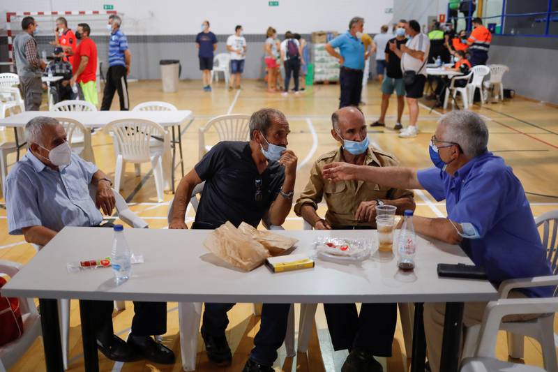 Residents rest inside a sports centre in Ronda after an evacuation as the flames closed in. Reuters