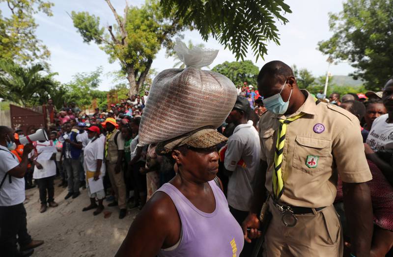 Camp Perrin residents receive food from the World Food Programme near Les Cayes on Thursday. Reuters
