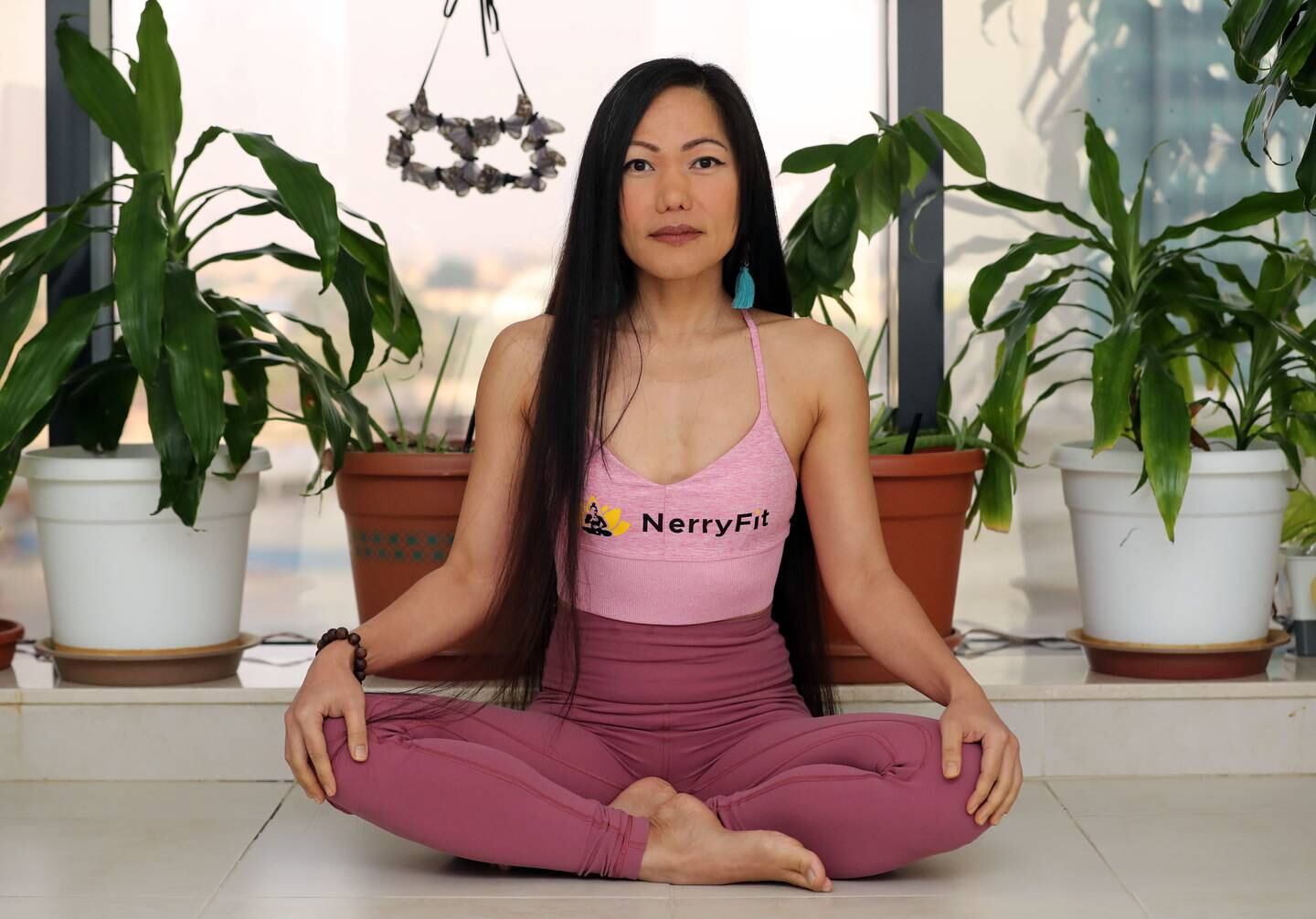 Nerry Toledo, who quit her job to pursue her dream of teaching yoga, derives happiness from knowing what she is doing has a lasting impact and because she chooses not to settle for a mundane existence. Photo: Chris Whiteoak / The National