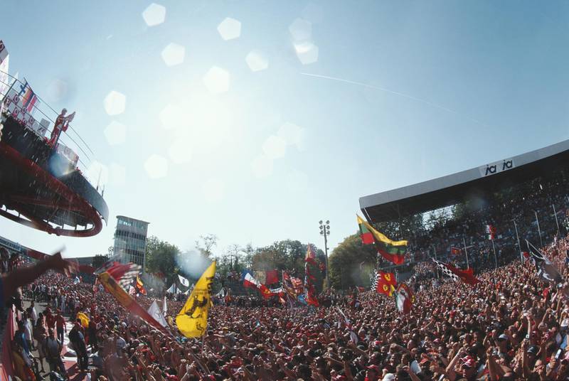 Michael Schumacher of Germany and driver of the #5 Scuderia Ferrari Marlboro Ferrari 248 F1 Ferrari V8 salutes the flag wavingTifosi fans after winning his 90th Grand Prix at the Formula One Italian Grand Prix on 10 September 2006 at the Autodromo Nazionale Monza, Monza, Italy.  (Photo by Darren Heath/Getty Images)  