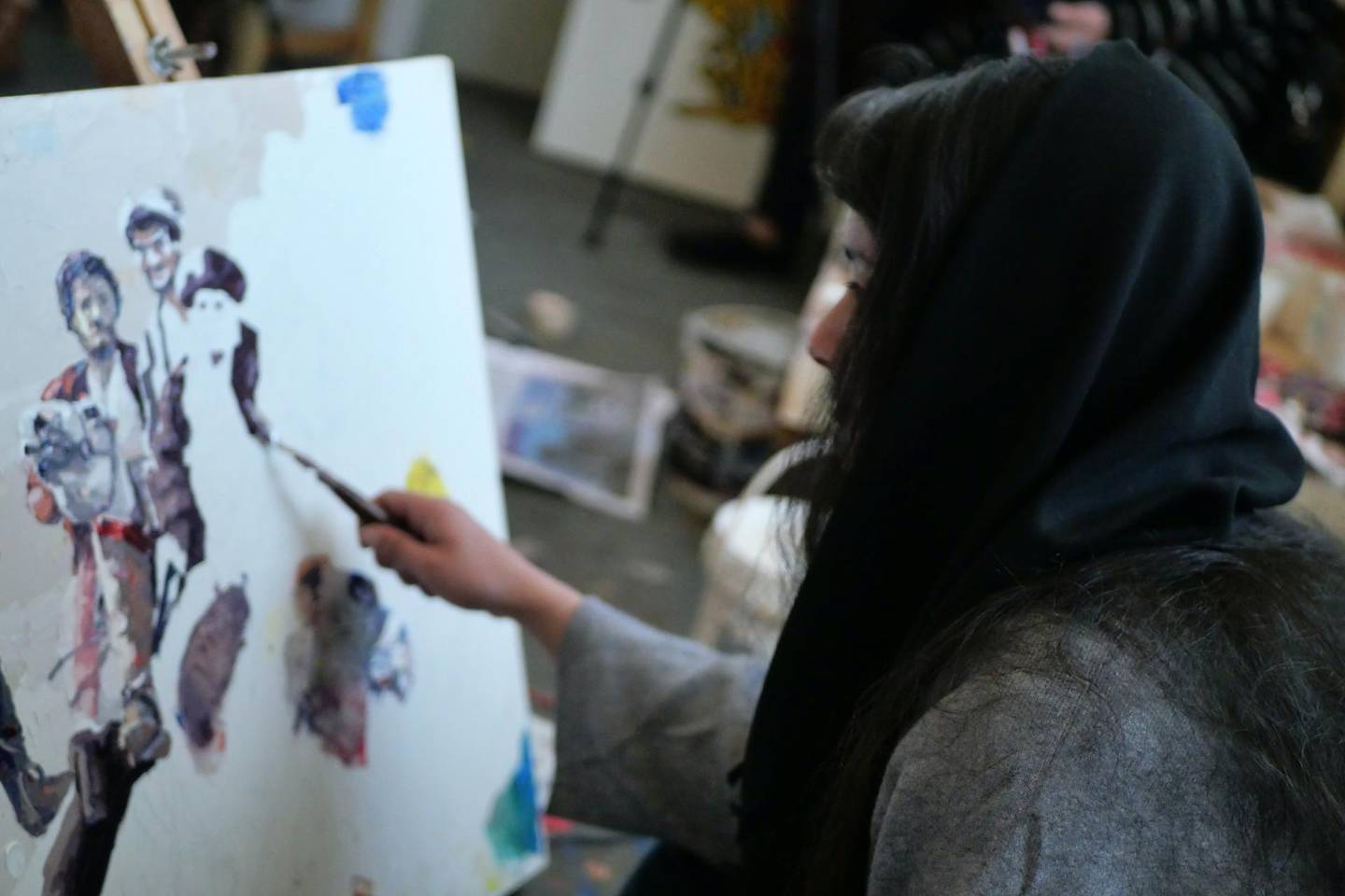 Pictured: A woman artist paints at ArtLords headquarters in Kabul. Photo by Charlie FaulknerFebruary 2021