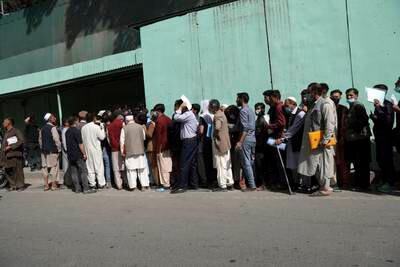Afghans wait in long lines for hours to get visas at the Iranian embassy, in Kabul.